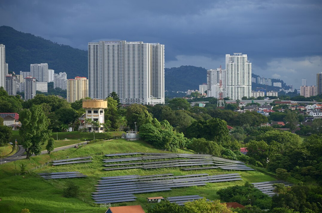 Field of solar panels with mountains in the background